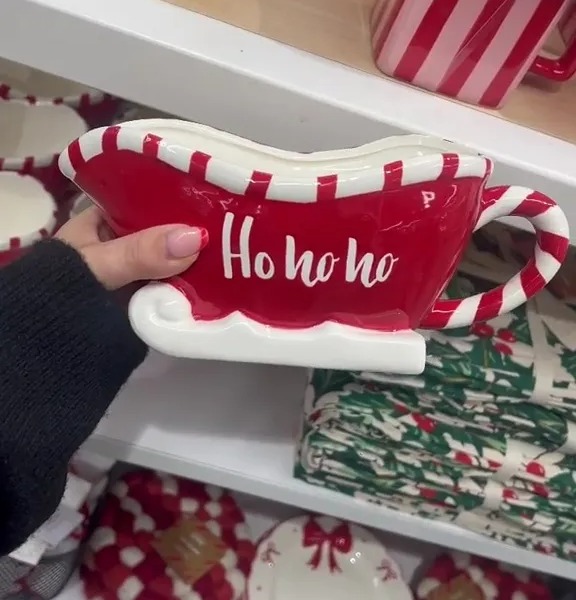 a person is holding a candy cane shaped bowl that says ho ho ho