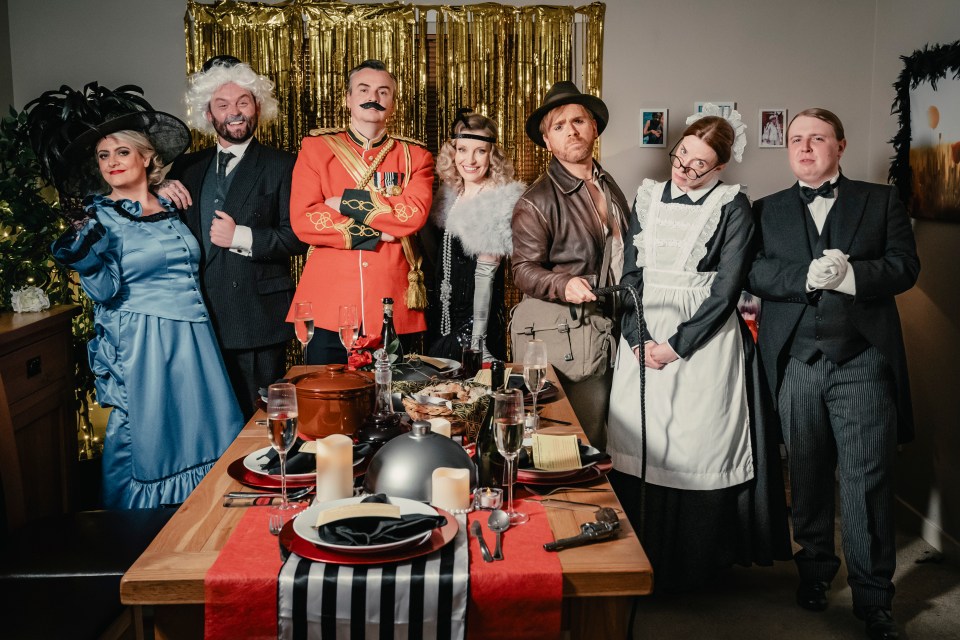 a group of people dressed in costumes standing around a table