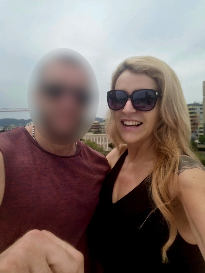 a woman wearing sunglasses stands next to a blurry man