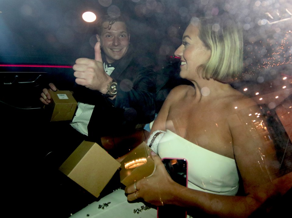 a man giving a thumbs up next to a woman in a white dress