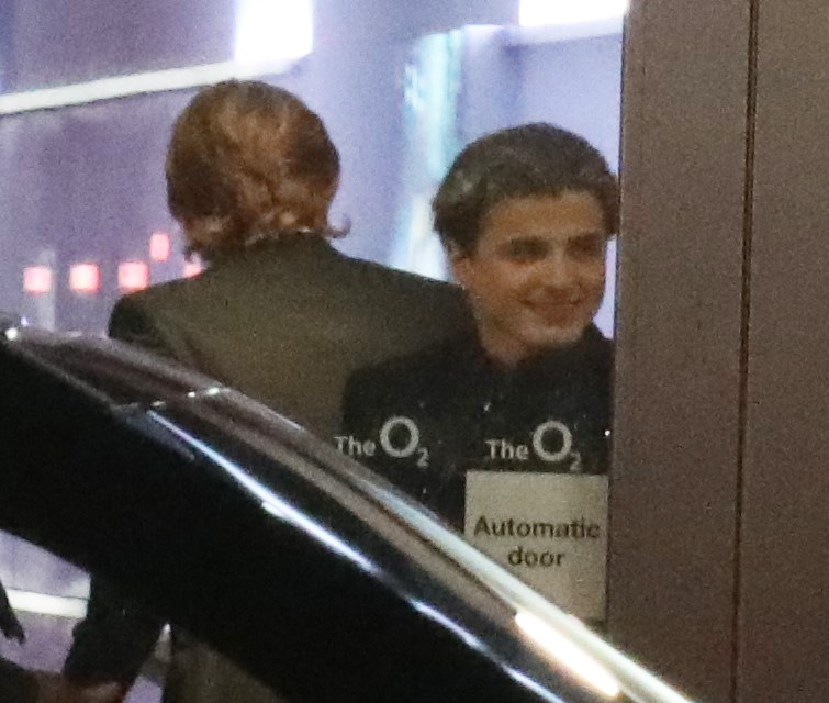 a man stands in front of a sign that says automatic door