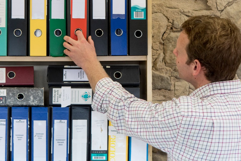 a man reaches for a binder labeled connect