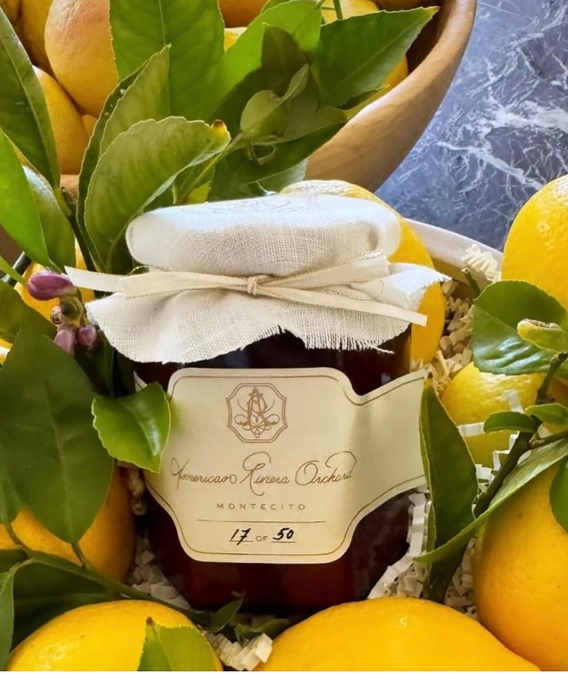 a jar of american famous orchard is surrounded by lemons