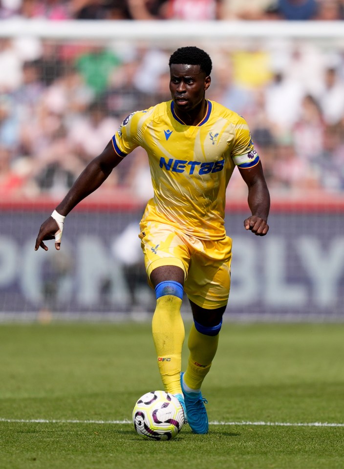 a soccer player wearing a yellow jersey with netbet on it