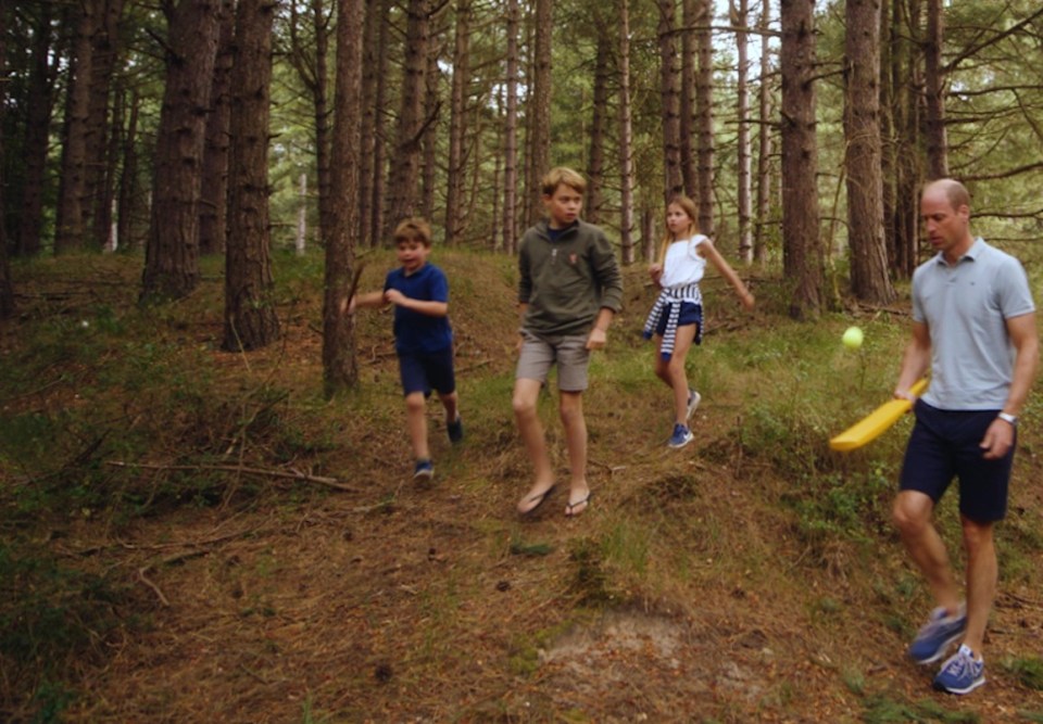 a man and two children are walking through the woods