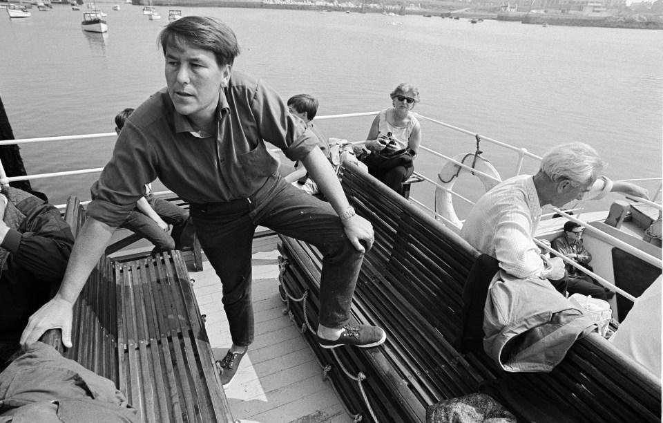 a black and white photo of people on a boat