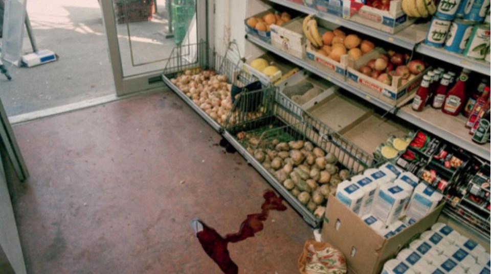 a grocery store with a cart full of potatoes and boxes of heinz ketchup