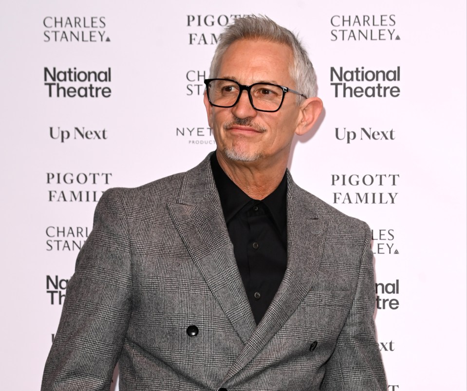 a man in a suit stands in front of a national theatre sign