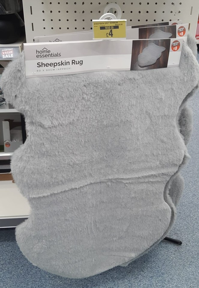 a home essentials sheepskin rug is on display in a store