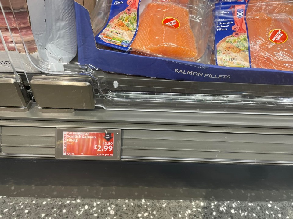 a display of salmon fillets with a price tag of 2.99