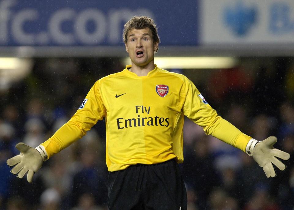 a soccer player wearing a yellow fly emirates jersey