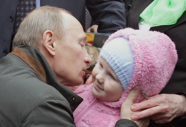 a man kisses a little girl on the cheek