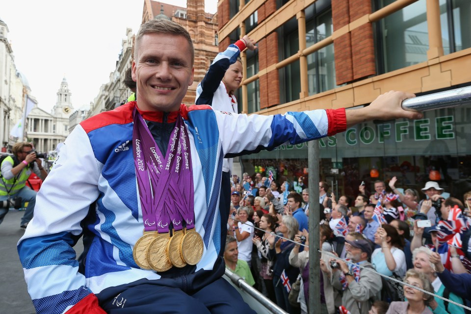 a man wearing a jacket that says ' london 2012 ' on it