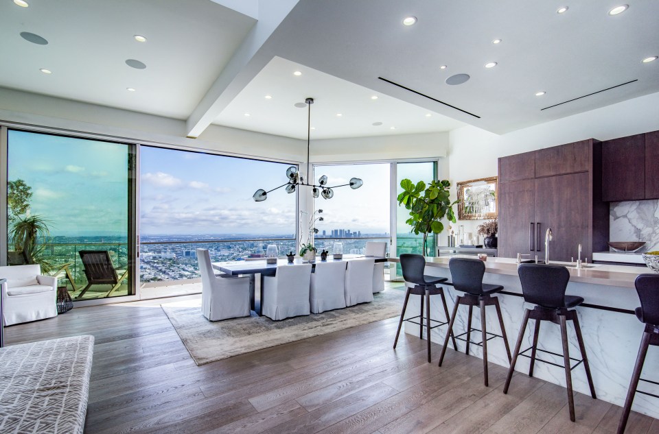 a kitchen and dining room with a view of the city