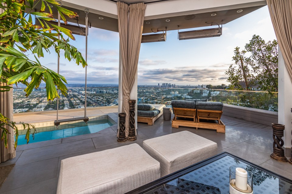 a view of a city from a balcony with a swimming pool