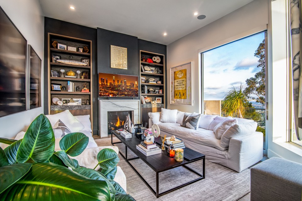 a living room with a white couch and a fireplace