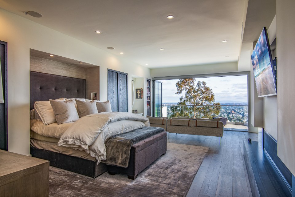 a bedroom with a large bed and a flat screen tv