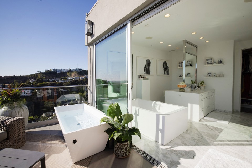 a bathtub in a bathroom with a view of a city