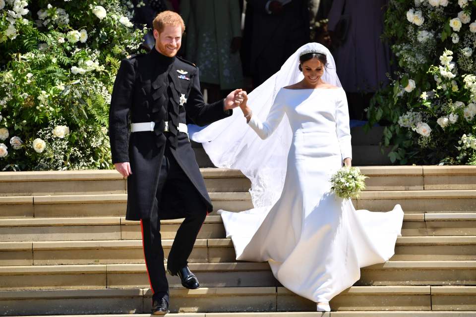 a bride and groom are walking down a set of stairs