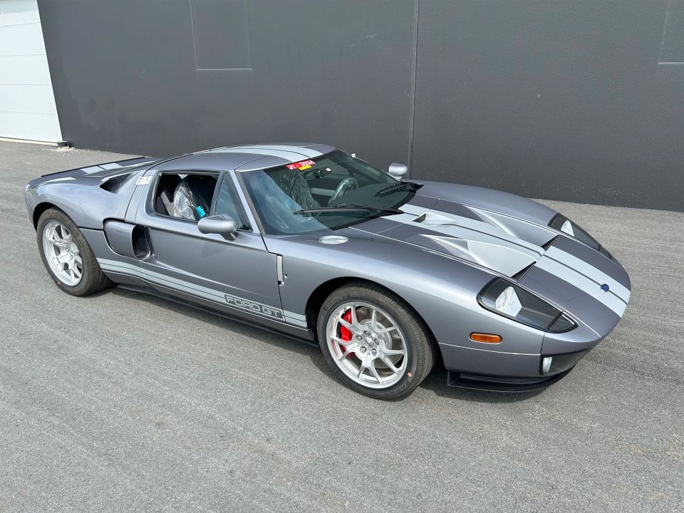 a ford gt is parked in front of a garage