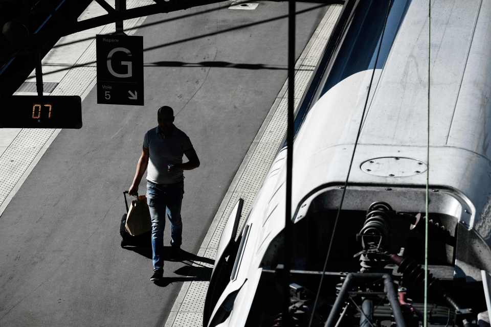 a man walking towards a sign that says g on it