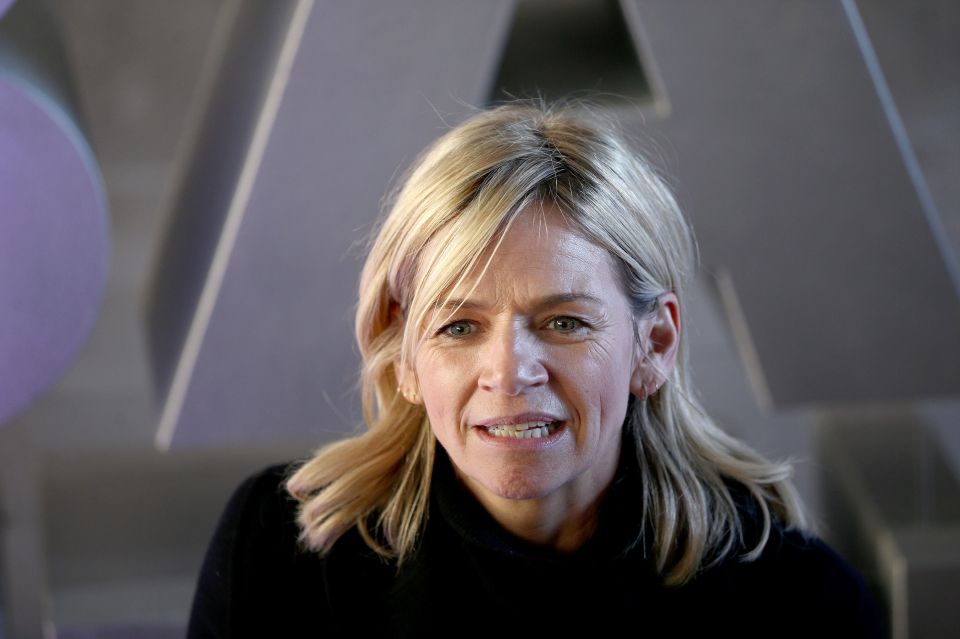 a close up of a woman 's face with a purple background