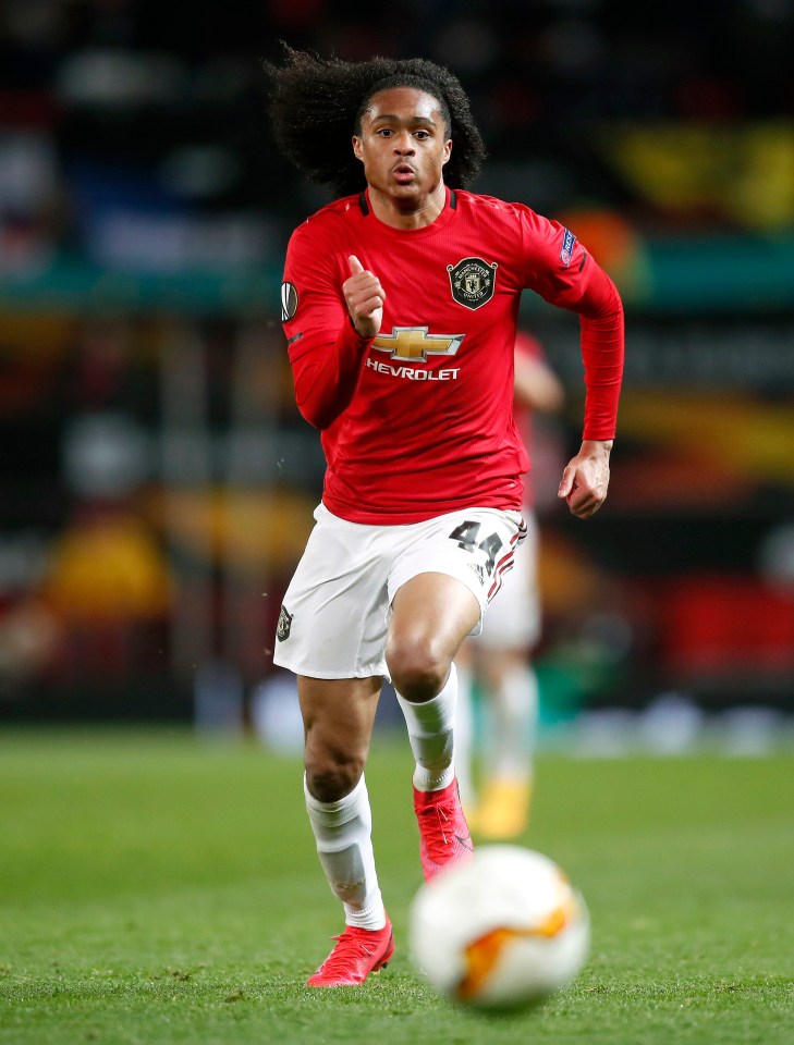 a soccer player wearing a red chevrolet jersey is running with the ball