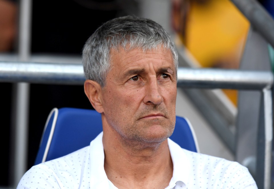 a man with gray hair is sitting in a blue chair