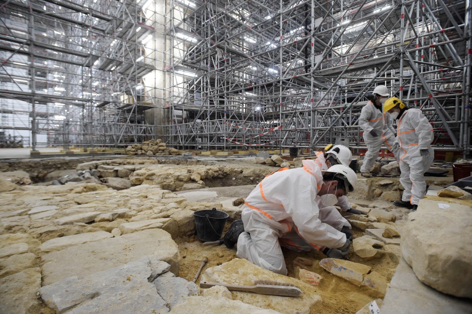 Archaeologists work on the historic cathedral after the harrowing fire in 2019