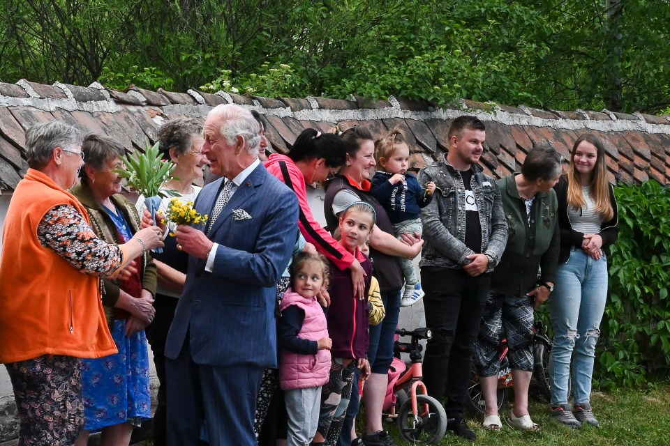 King Charles III receives flowers from locals as he arrives at his estate in eastern Transylvania last year