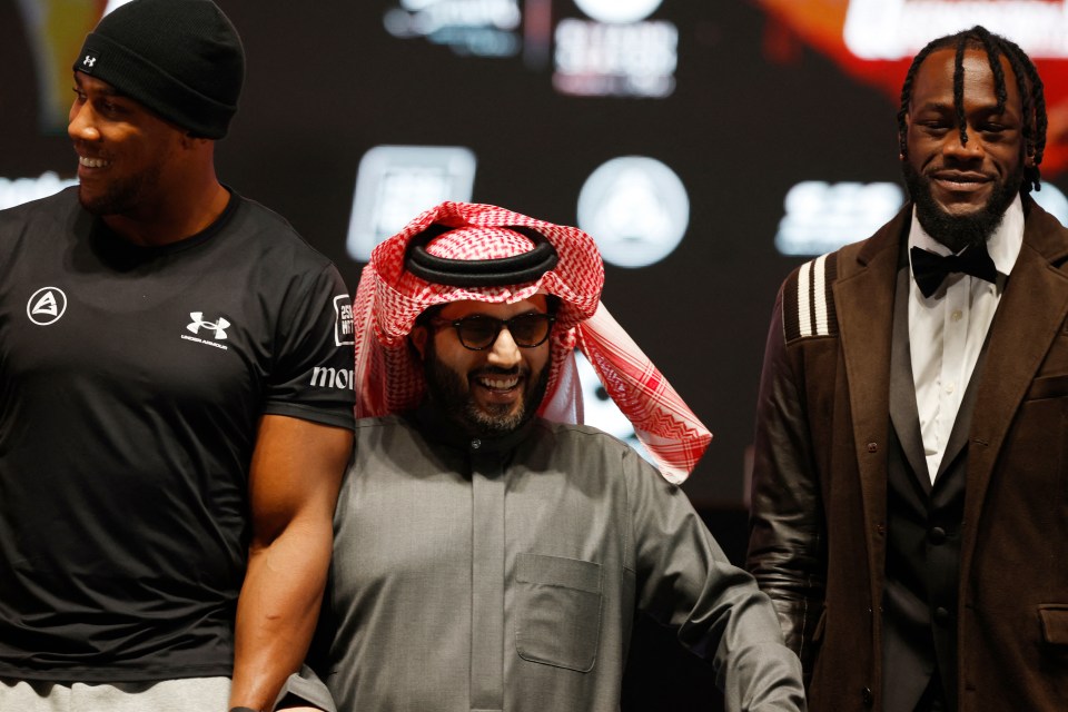 a man in a black under armour shirt stands next to two other men