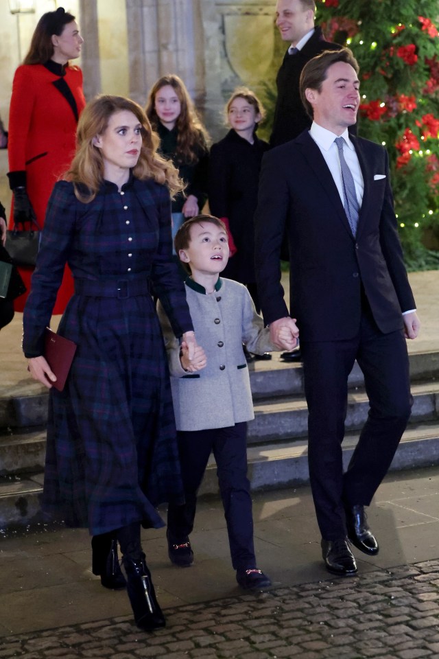 a man in a suit is holding a child 's hand