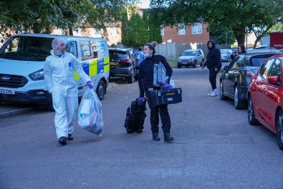 Forensic police officers outside the Luton tower block