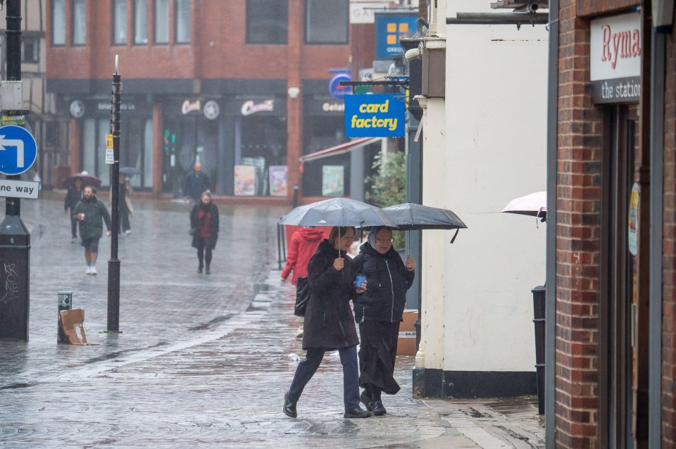 Brits braving the downpours in Windsor, Berkshire this morning