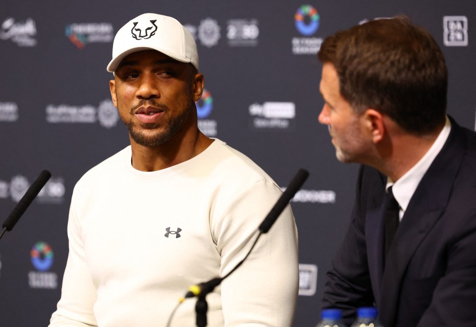 a man wearing an under armour shirt talks to another man