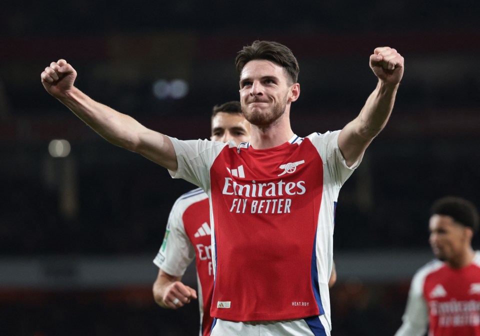 soccer player wearing a red emirates fly better jersey