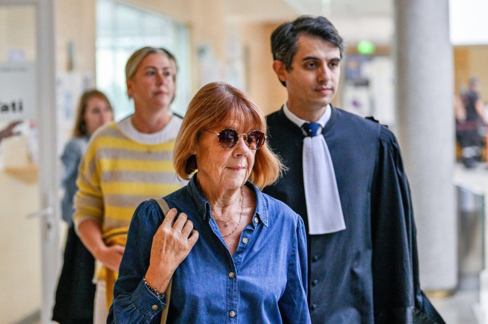 a woman wearing sunglasses is walking with a lawyer