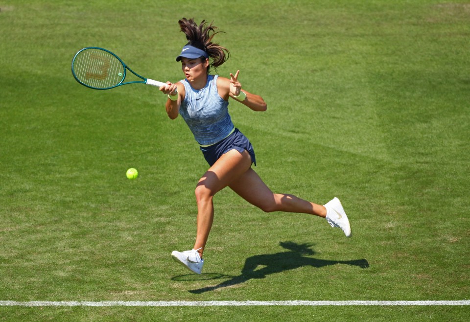 a woman playing tennis with a wilson racquet