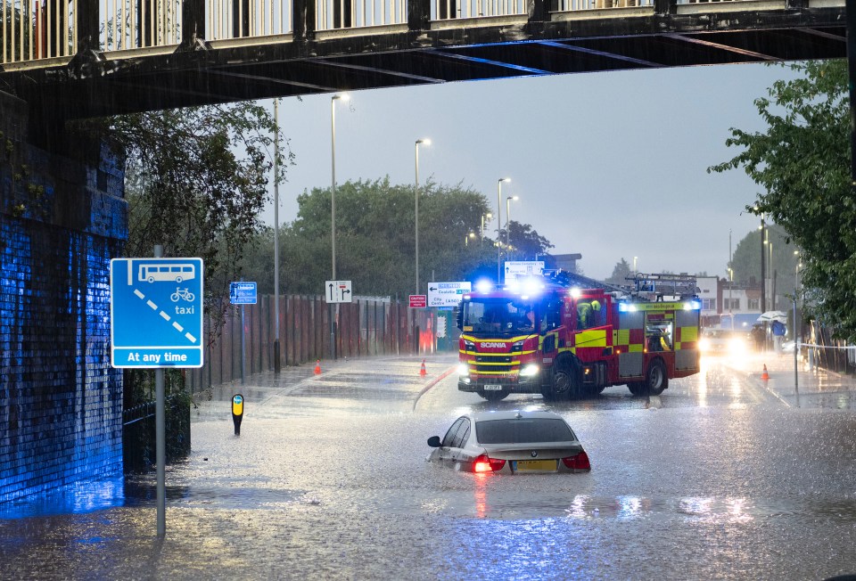 A car trapped in floodwater on Fosse Road North in Leicester