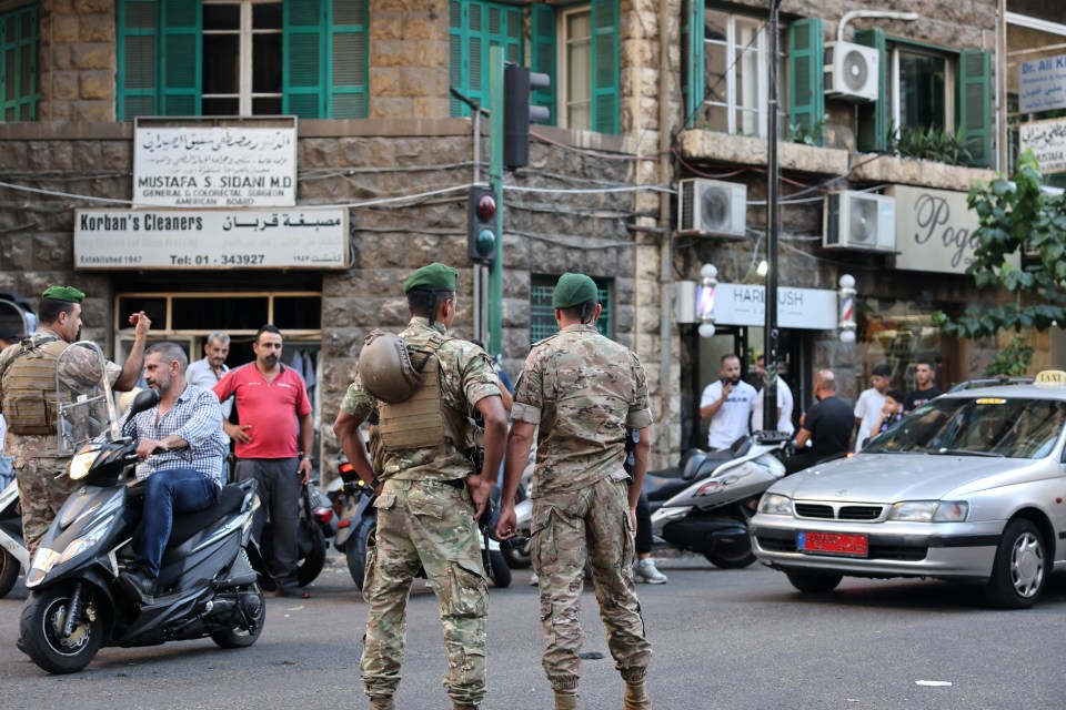 Soldiers stand guard near a hospital in Beirut after the pager attack