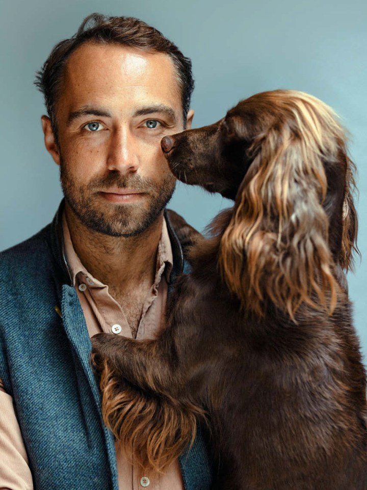 a man with a beard is holding a brown dog