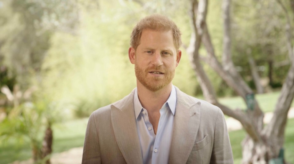 a man with a beard is wearing a tan suit