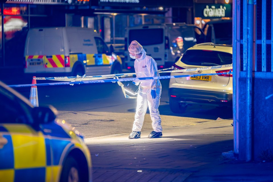 a man in a white suit is standing in front of a car that has a license plate that says hk04 vmr