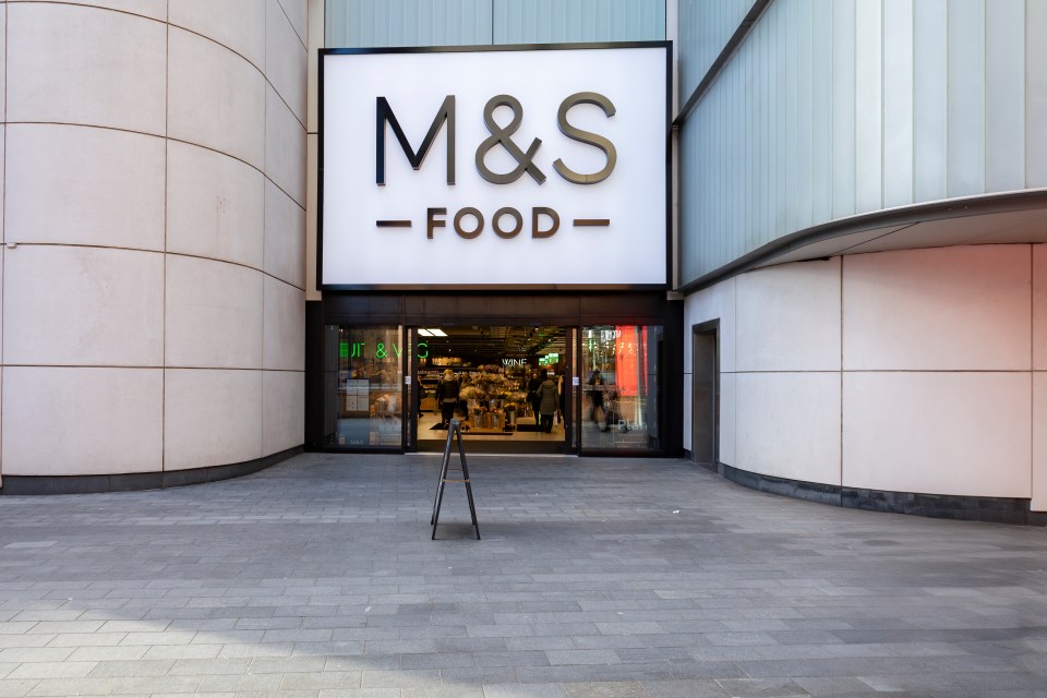 a m & s food store with a sign above it