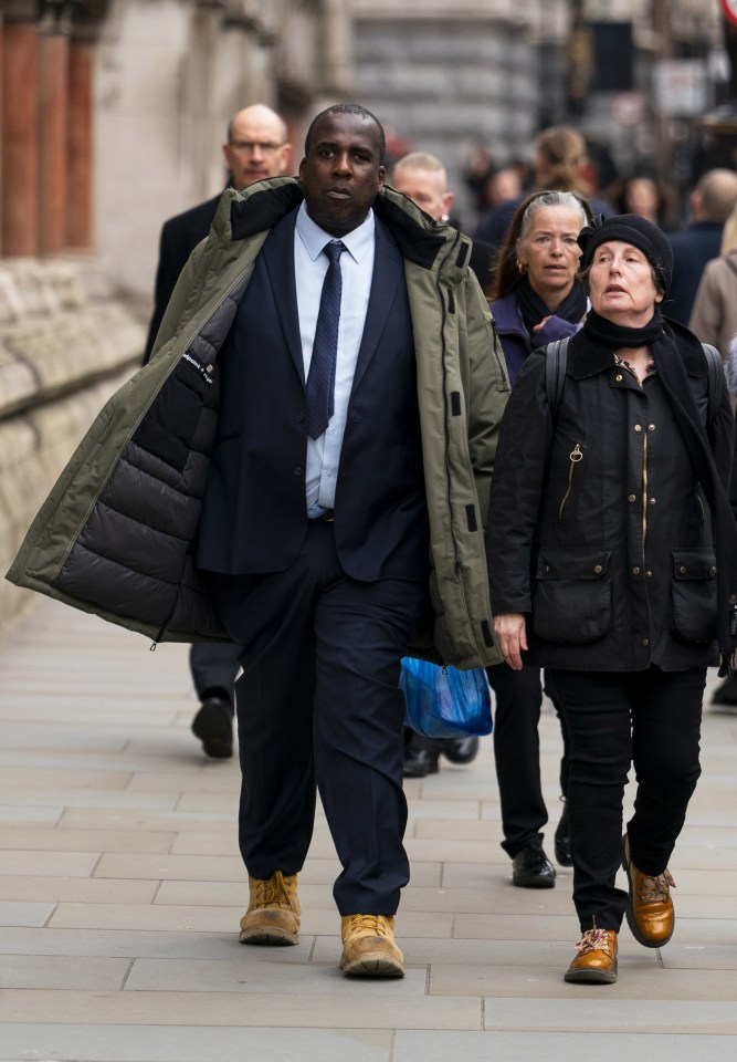 a man in a suit and tie is walking down the street