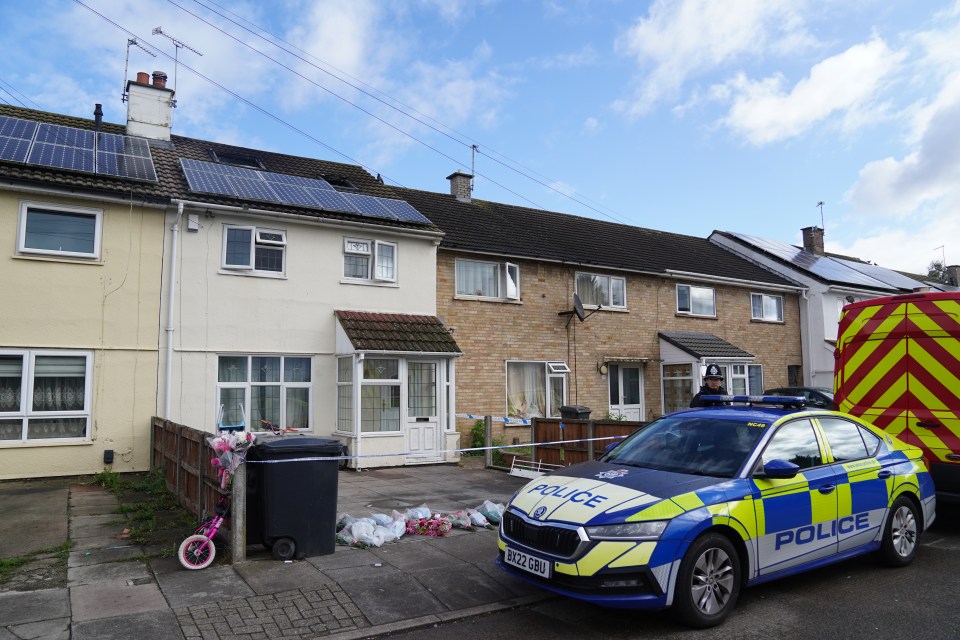 a police car is parked in front of a house