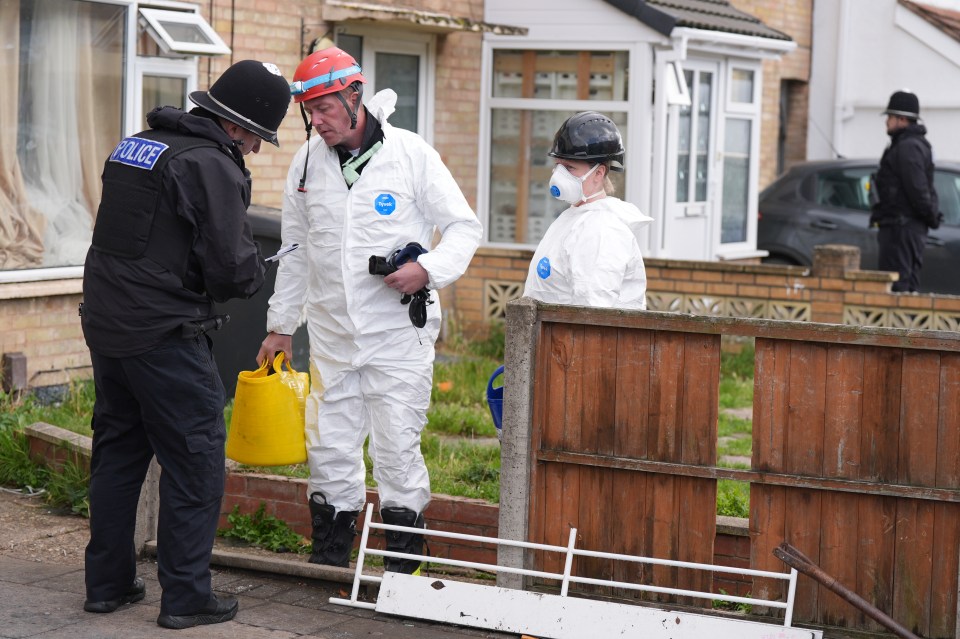 a police officer is talking to a man in a hazmat suit