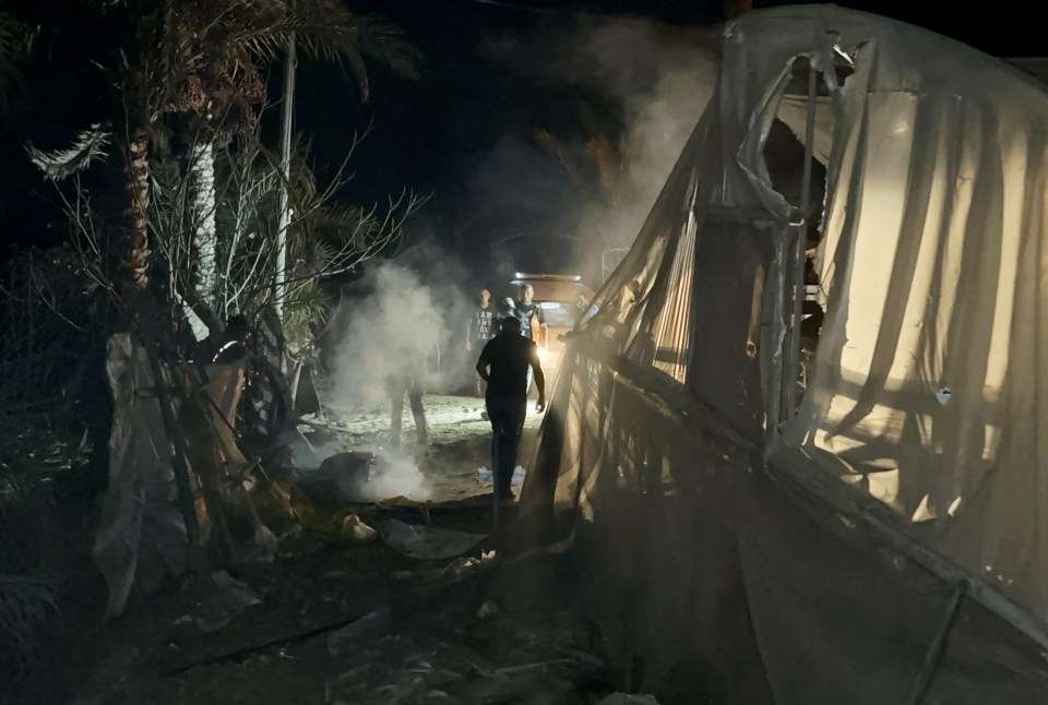 Smokes billows out near a tent in the camp