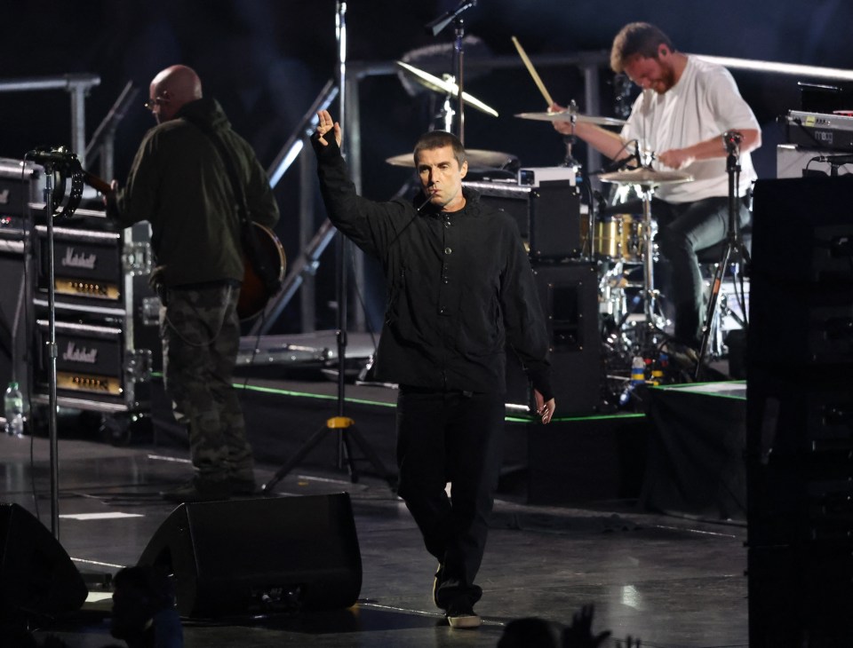 a man stands on a stage with a marshall amp in the background