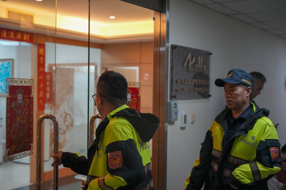 Police officers at Taiwanese company Gold Apollo office